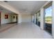 The sunroom has golf course views, tiled floors, and lots of natural light from sliding glass doors at 5621 Palm Aire Dr, Sarasota, FL 34243