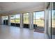 Enclosed sunroom with tiled flooring and sliding glass doors opening to a lush green golf course at 5621 Palm Aire Dr, Sarasota, FL 34243