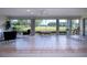 Bright sunroom with expansive windows offering panoramic views of the golf course and lush surroundings at 5621 Palm Aire Dr, Sarasota, FL 34243