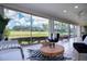 Bright sunroom boasting panoramic golf course views, creating a serene and inviting space for relaxation and entertainment at 5621 Palm Aire Dr, Sarasota, FL 34243