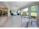 Inviting sunroom featuring views of the golf course and providing a seamless transition to the dining and living spaces at 5621 Palm Aire Dr, Sarasota, FL 34243