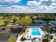 Aerial view of the community pool, with ample seating, and landscaped surroundings at 5621 Palm Aire Dr, Sarasota, FL 34243
