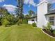 Lush backyard featuring a variety of plants, lawn, and privacy hedges at 5646 Country Lakes Dr, Sarasota, FL 34243