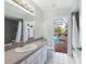 Bright bathroom with a view of the pool and outdoor area, offering a relaxing spa-like experience at 5646 Country Lakes Dr, Sarasota, FL 34243