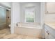 Well-lit bathroom with a bathtub and a separate shower, offering a relaxing atmosphere at 5646 Country Lakes Dr, Sarasota, FL 34243