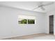 Bright bedroom featuring natural light, carpet flooring, and closet access at 5646 Country Lakes Dr, Sarasota, FL 34243
