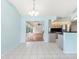 The dining area features white tile floors, large windows, and access to the kitchen at 5646 Country Lakes Dr, Sarasota, FL 34243