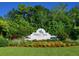 A sign for Palm Aire Country Club is displayed behind a bed of vibrant flowers and greenery at 5646 Country Lakes Dr, Sarasota, FL 34243