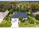 Stunning home featuring lush landscaping, a screened pool, and a pristine, well-maintained exterior at 5646 Country Lakes Dr, Sarasota, FL 34243