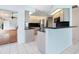 Bright kitchen features stainless appliances, light wood cabinets, and a breakfast bar at 5646 Country Lakes Dr, Sarasota, FL 34243