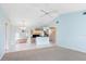 Open-concept space featuring tile flooring, neutral walls, and views into the kitchen and screened patio at 5646 Country Lakes Dr, Sarasota, FL 34243