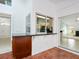 Wet bar counter in the lanai with granite countertops, wood cabinets, and pool views at 5646 Country Lakes Dr, Sarasota, FL 34243