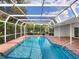 Secluded screened in pool area, set amongst lush trees and landscaping at 5646 Country Lakes Dr, Sarasota, FL 34243