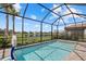 Sparkling screened-in pool with basketball hoop and views of the lake and surrounding community at 5808 Silverside Pine Ct, Bradenton, FL 34211