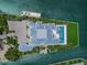 Waterfront property features a sprawling home, lush landscaping, private boat dock, and a refreshing pool at 612 Juan Anasco Dr, Longboat Key, FL 34228