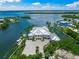Luxury waterfront home boasts lush landscaping, a private dock, and spacious driveway in a prime location at 612 Juan Anasco Dr, Longboat Key, FL 34228