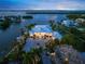 Waterfront home with private dock, lush landscaping, and sunset views at 612 Juan Anasco Dr, Longboat Key, FL 34228