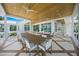 Outdoor dining and living space with a wood ceiling, scenic views, and a built-in grill at 612 Juan Anasco Dr, Longboat Key, FL 34228