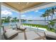 Beautiful balcony overlooking lush landscaping, tranquil waters, and a sparkling pool at 612 Juan Anasco Dr, Longboat Key, FL 34228