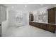 Bright bathroom featuring dual vanities, soaking tub, chandelier, and large window at 612 Juan Anasco Dr, Longboat Key, FL 34228