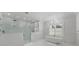Bright, white bathroom with soaking tub, walk-in shower with glass enclosure, and marble tile at 612 Juan Anasco Dr, Longboat Key, FL 34228