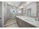 Modern bathroom with dual sinks, walk-in shower, and stylish gray-toned tile at 612 Juan Anasco Dr, Longboat Key, FL 34228