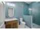 Stylish bathroom with blue accent tiles, natural wood vanity, white countertops, and glass-enclosed shower at 612 Juan Anasco Dr, Longboat Key, FL 34228