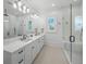 This bathroom features double sinks, a glass shower, and lots of natural light at 612 Juan Anasco Dr, Longboat Key, FL 34228