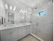 This bathroom features double sinks, a glass shower, and lots of natural light at 612 Juan Anasco Dr, Longboat Key, FL 34228