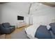 Spacious bedroom with seating area, wall-mounted TV, and light, neutral decor at 612 Juan Anasco Dr, Longboat Key, FL 34228