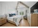 Bright bedroom with vaulted ceiling, wood beams, and decoratively painted seahorses at 612 Juan Anasco Dr, Longboat Key, FL 34228