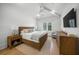 Inviting bedroom with vaulted ceilings, hardwood floors, fan, and large windows at 612 Juan Anasco Dr, Longboat Key, FL 34228