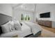 Cozy bedroom featuring vaulted ceilings, hardwood floors, ceiling fan, and large windows at 612 Juan Anasco Dr, Longboat Key, FL 34228