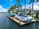Private boat dock on the water with two boats moored, providing a boater's paradise with waterfront access at 612 Juan Anasco Dr, Longboat Key, FL 34228