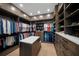 Well-organized walk-in closet with shelves, drawers, hanging rods, and an island for folding clothes at 612 Juan Anasco Dr, Longboat Key, FL 34228