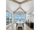 Open dining room with vaulted ceilings, large windows, and views of the water at 612 Juan Anasco Dr, Longboat Key, FL 34228