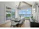 Elegant dining room with scenic waterfront views and a modern chandelier at 612 Juan Anasco Dr, Longboat Key, FL 34228