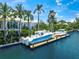 Luxury waterfront home with a private dock featuring space for two boats and lush landscaping at 612 Juan Anasco Dr, Longboat Key, FL 34228