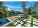 Private waterfront dock with lush landscaping and paver walkway, providing convenient access to the water at 612 Juan Anasco Dr, Longboat Key, FL 34228