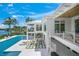 Stunning waterfront home with a pool, multiple balconies, and lush tropical landscaping at 612 Juan Anasco Dr, Longboat Key, FL 34228
