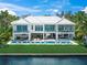 Luxury home boasts spacious balconies, a pool with lounge chairs, and an outdoor dining area at 612 Juan Anasco Dr, Longboat Key, FL 34228