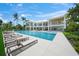 Stunning waterfront property with a large swimming pool, elegant architecture, and ample outdoor space for leisure and recreation at 612 Juan Anasco Dr, Longboat Key, FL 34228