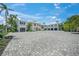 Luxury home features a spacious driveway, covered parking, and elegant staircase leading to the entrance at 612 Juan Anasco Dr, Longboat Key, FL 34228