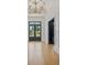 Bright foyer featuring herringbone wood floors, paneled walls, and a modern chandelier at 612 Juan Anasco Dr, Longboat Key, FL 34228