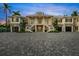 Elegant home with a spacious driveway and well-maintained landscaping at 612 Juan Anasco Dr, Longboat Key, FL 34228