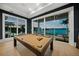 Entertainers game room with a pool table, water view, and sliding glass doors leading to a patio at 612 Juan Anasco Dr, Longboat Key, FL 34228