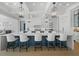 Bright kitchen boasts an oversized island, white cabinetry, and stylish pendant lighting at 612 Juan Anasco Dr, Longboat Key, FL 34228