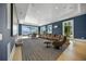 Spacious living room with hardwood floors, a large sectional, water views, and plenty of natural light at 612 Juan Anasco Dr, Longboat Key, FL 34228
