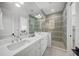 Elegant bathroom boasts a double vanity, a glass-enclosed shower, and upscale finishes at 612 Juan Anasco Dr, Longboat Key, FL 34228