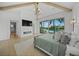 Bright main bedroom boasts waterfront views, vaulted ceiling, and modern fireplace at 612 Juan Anasco Dr, Longboat Key, FL 34228